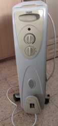 Электрический радиатор для отопления комнаты. Имеется переключатель с 4 положениями: включение-выключение и 3 положения мощности обогрева image 1